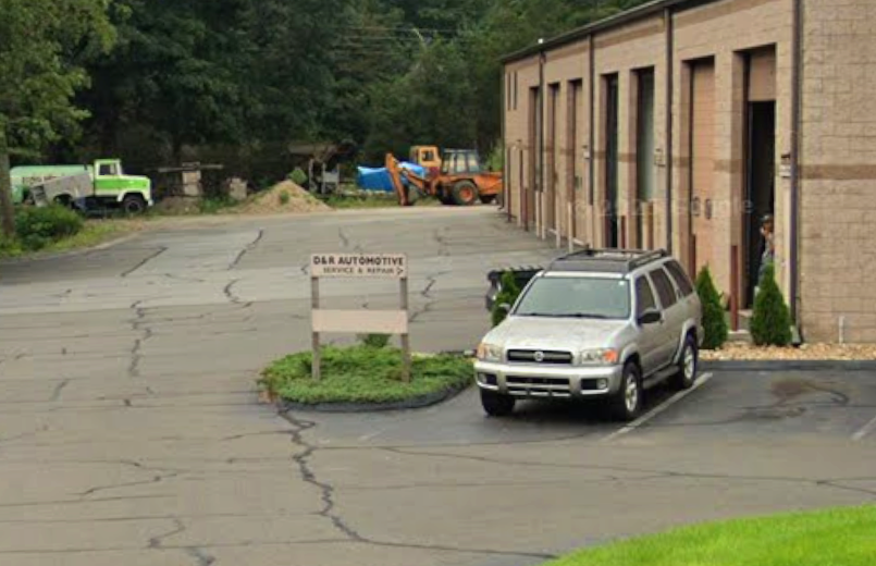 D&R Automotive service and repair sign in the shop parking lot